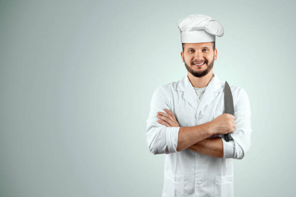 istock A man with a beard, a cook in a hat and a knife in his hand Isolated on a white background. Cooking, recipes, cuisine. 1174354557