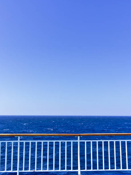 istock Ship deck railing  while sailing on open sea. Vivid blue color with copy space. 1174354672
