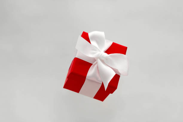 istock red gift box with white bow levitating isolated on a gray background 1174357581