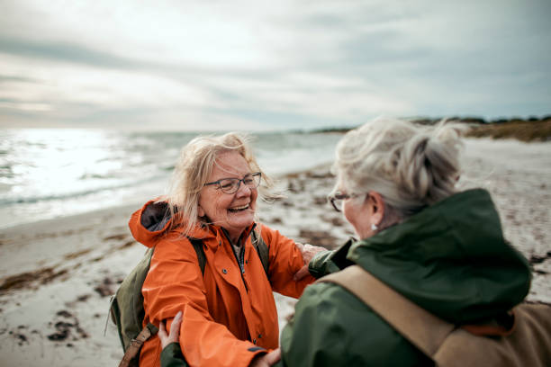 istock Seniors walking by the beach 1174357702