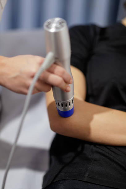 istock Implementing wave therapy to a patient with injured elbow 1174365954
