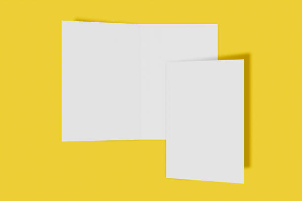 istock Two Mockup vertical booklet, brochure, invitation isolated on a yellow background with hard cover and realistic shadow. 3D rendering. 1174369022