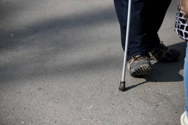 istock disabled or elderly person with a stick 1174369244