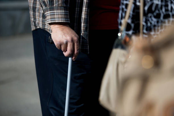 istock disabled or elderly person with a stick 1174369260