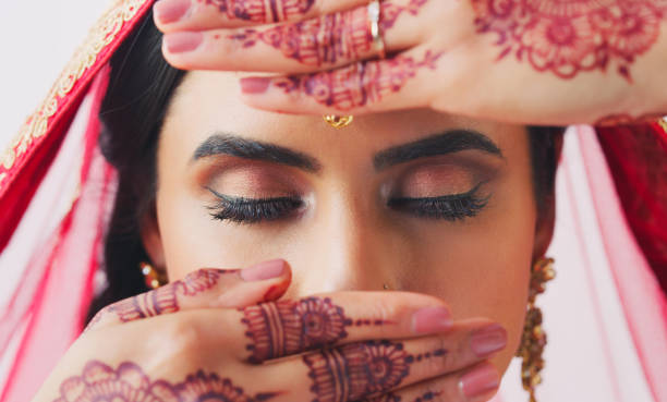 An important part of her culture Cropped shot of a beautiful young woman covering her face with her hands on her wedding day human hand traditional culture india ethnic stock pictures, royalty-free photos & images