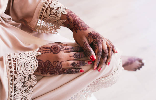 istock Adorning her hands with beautiful mehndi 1174369534