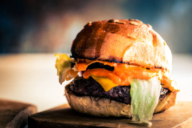 istock Fresh flame grilled burger on white wooden surface 1174373780