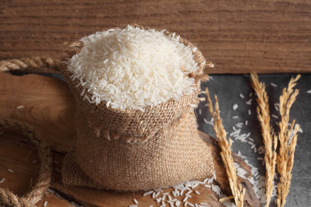 istock Thai white jasmine rice in sack bag in kitchen with a blank space for a text, Thai agriculture concept 1174373900