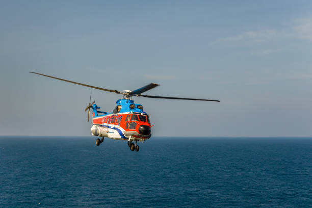 istock helicopter flying over the sea 1174381656