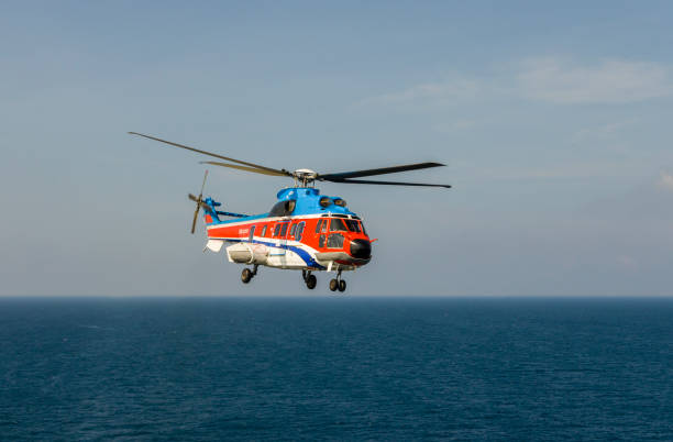 istock helicopter flying over the sea 1174381695