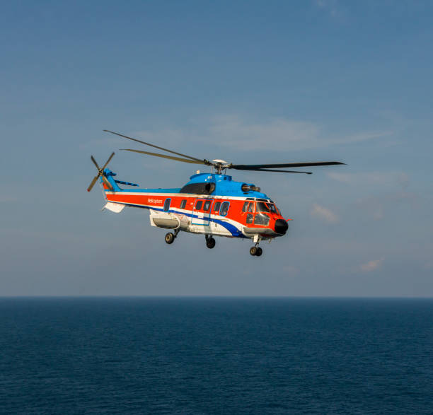 istock helicopter flying over the sea 1174381742