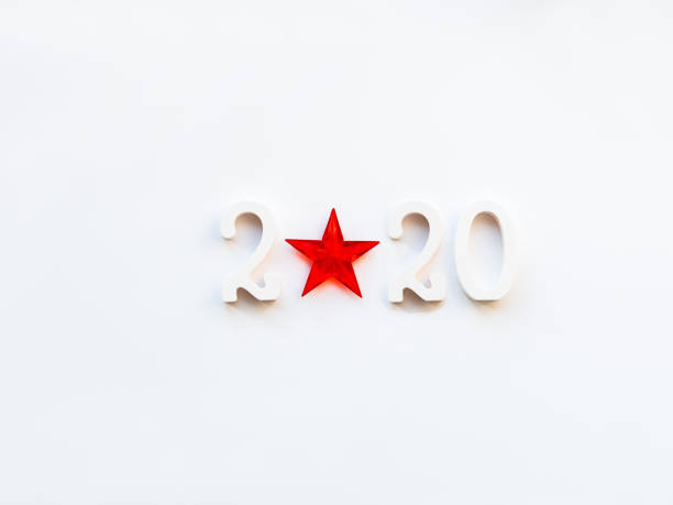 istock New Year 2020 background with bright red star. Numbers 2020 on white copy space with decorative ball for Christmas tree. 1174382117