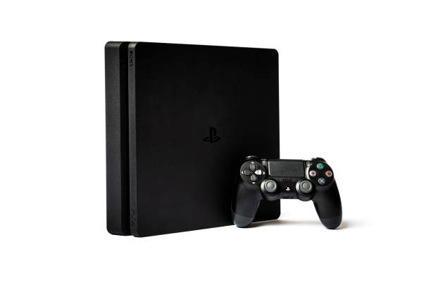 Sony PlayStation 4  and game controller on white background stock photo