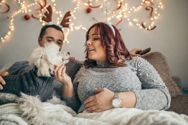 istock Millennial couple playing with cute dog 1174386705