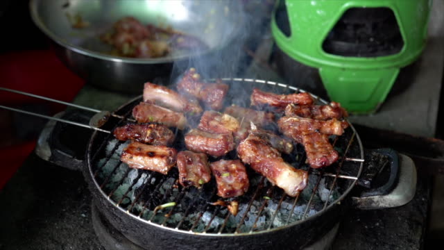 4K Slow motion footage of grilling Pork on charcoal grill, Cooking food and barbecue concept