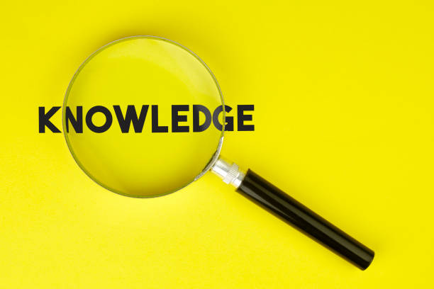 istock Magnifier And Knowledge Text On Yellow Background Stock Photo 1174391396
