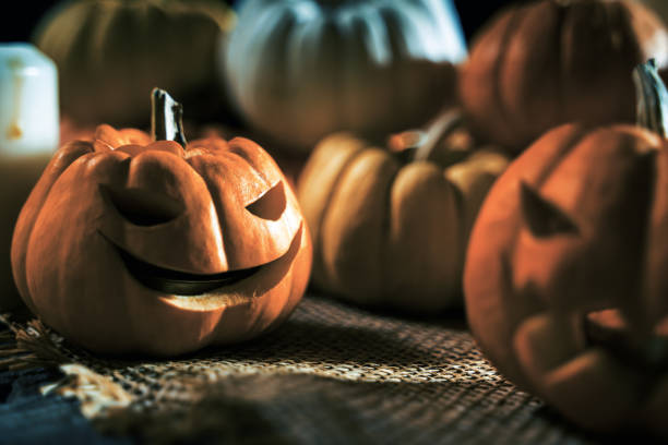 istock Pumpkins with Jack o lantern face decoration for Halloween background 1174396272