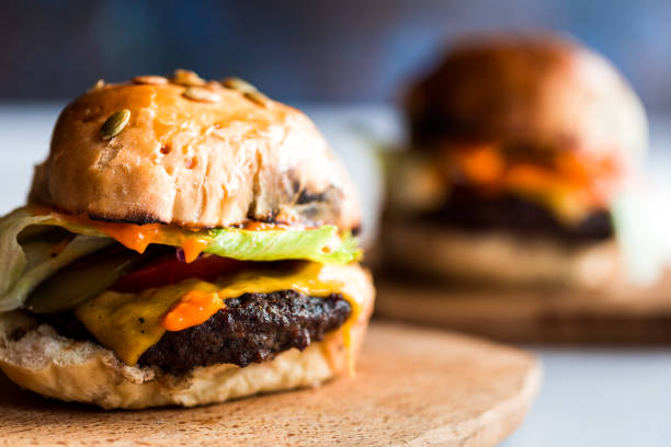 istock Fresh flame grilled burgers displayed on white wooden surface 1174397314