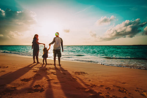 happy family with kids on play on sunset beach - travel baby people traveling family imagens e fotografias de stock