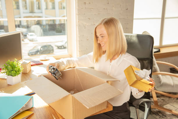 istock A young businesswoman moving in office, getting new work place 1174401496