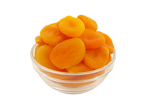 Dried apricots fruits in glass bowl isolated on white background
