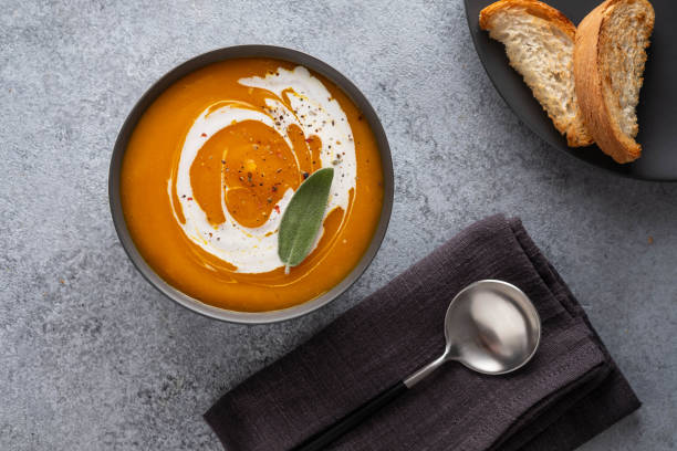 istock Pumpkin soup with sage on grey background. Top view. 1174404188