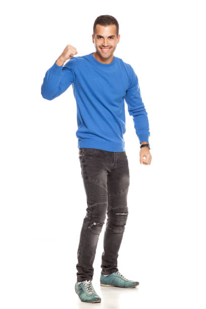 istock handsome happy young man in blouse and jeans  on white background 1174406497