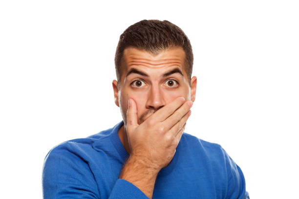 istock Portrait of young shocked man on white background 1174406534