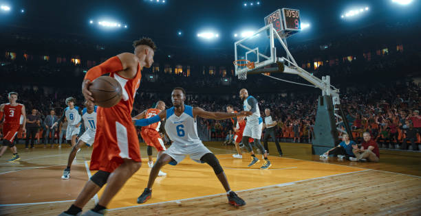 Basketball players on big professional arena during the game. Tense moment of the game. Celebration Basketball players on big professional arena during the game. Tense moment of the game. Celebration basketball player photos stock pictures, royalty-free photos & images