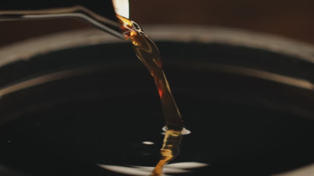 Close-up of coffee being poured in container