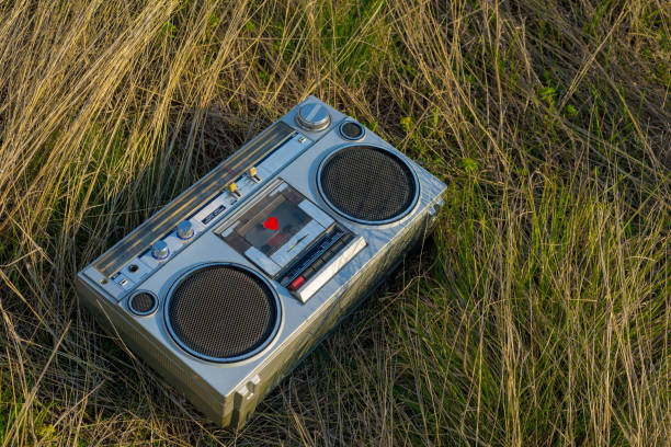 istock Listening a music from old case recorder in the park 1174407690