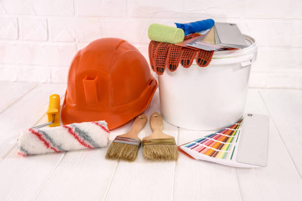 istock Painting tools with bucket on wooden table 1174408586