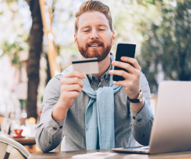istock Man paying with credit card on smart phone 1174409364
