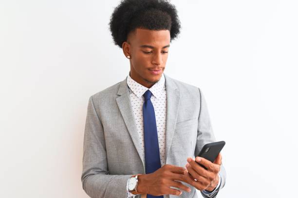 istock Young african american businessman using smartphone over isolated white background with a confident expression on smart face thinking serious 1174409865