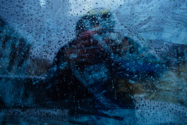 window in the rain window dripping drops during the rain, a man stands behind the glass water thinking bubble drop stock pictures, royalty-free photos & images