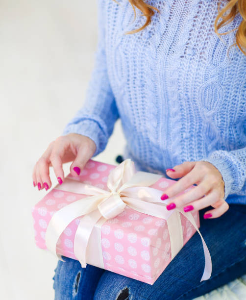istock Closeup woman keeping gift on knees 1174411111