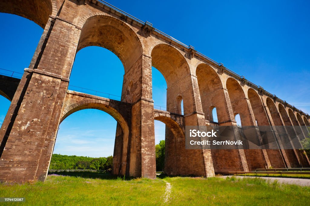 Remarkable bridge view of viaduct of Chaumont, France Remarkable bridge viaduct of Chaumont against blue sky, France, Europe Viaduct Stock Photo Remarkable bridge view of viaduct of Chaumont, France Remarkable bridge viaduct of Chaumont against blue sky, France, Europe Viaduct Stock Photo