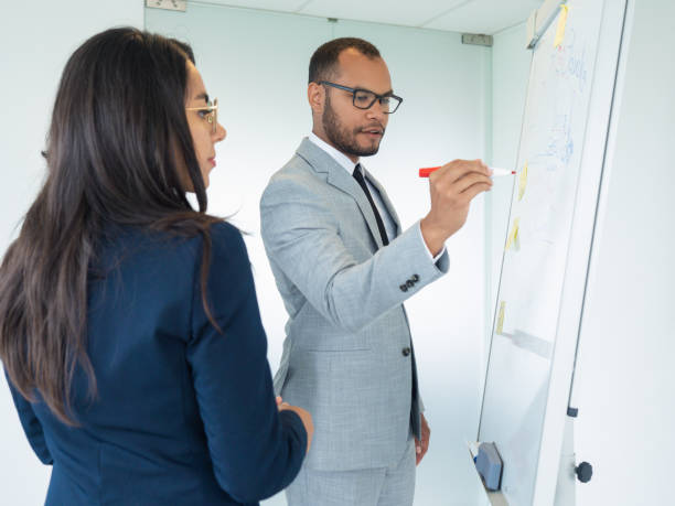 istock Young male business leader presenting report 1174413402