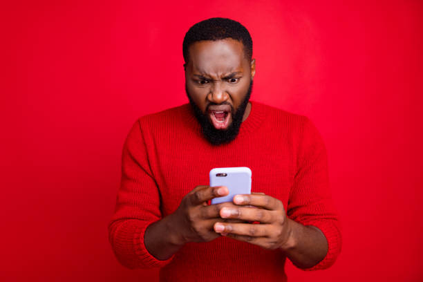istock Close-up portrait of his he nice attractive irritated annoyed outraged bearded guy using wireless connection app 5g blog post smm spam messenger isolated over bright vivid shine red background 1174413963