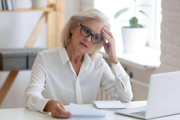 istock Pensive senior woman thinking of problem solution in office 1174414064
