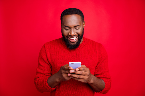 Close-up portrait of his he nice attractive cheerful cheery glad bearded guy, chatting 5g app wireless connection playing game isolated over bright vivid shine red background