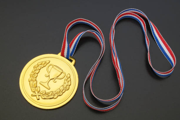istock Gold medal with ribbon on black table 1174414160