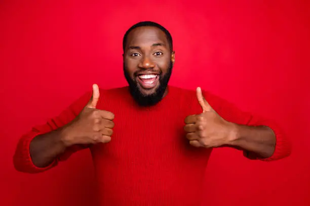 Photo of Close-up portrait of his he nice attractive cheerful cherry content positive bearded, guy showing thumbs up ad advert solution isolated over bright vivid shine red background