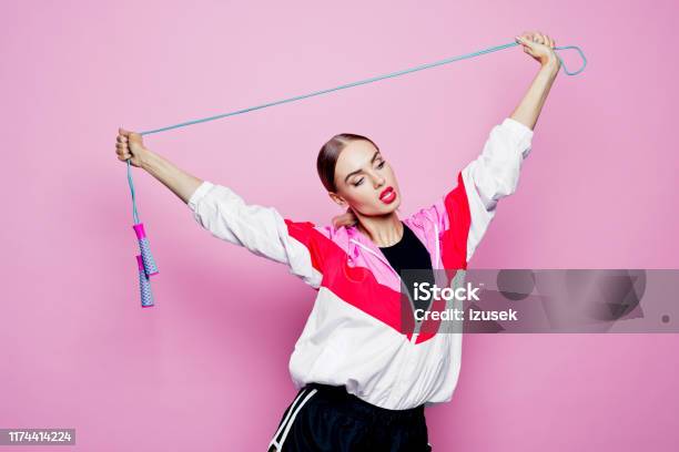 80s Style Portrait Of Smiling In Sports Clothes Against Pink Background Stock Photo - Download Image Now