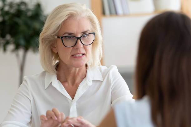 istock Female employees talk in office discussing ideas 1174414296
