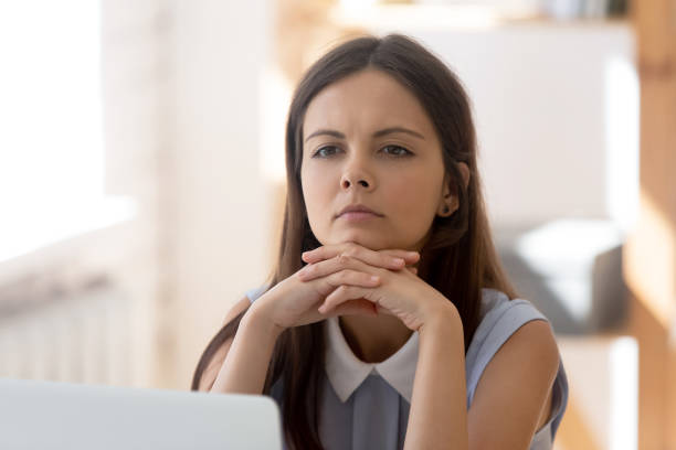 istock Pensive female employee distracted from work thinking 1174414438