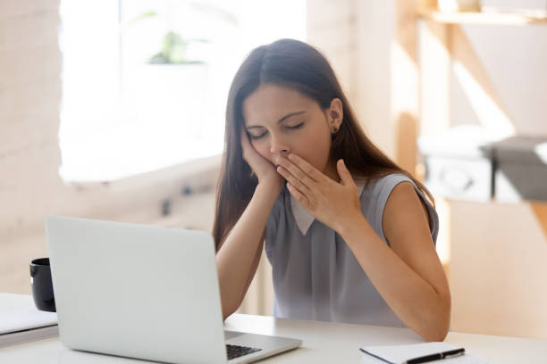 istock Exhausted female employee yawn feeling sleepy at workplace 1174414465