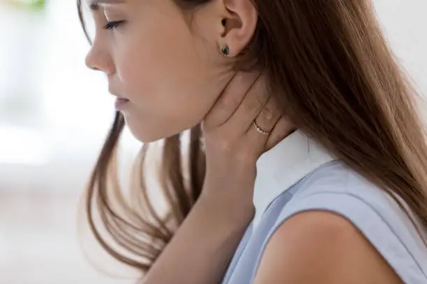 Unhealthy young woman touch neck hard to swallow having discomfort or painful feeling, unwell sad female employee suffering from angina or tonsillitis, sore throat, experience loss of voice