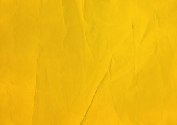 istock yellow crumpled paper texture background 1174415056