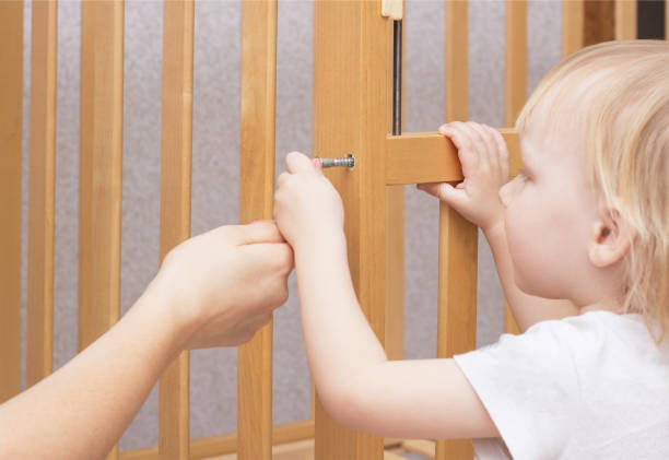 istock Mother and child are assembling a crib, close-up, caucasian, interior 1174415407